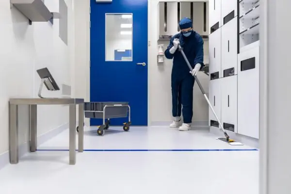 worker cleaning floor in medical facility